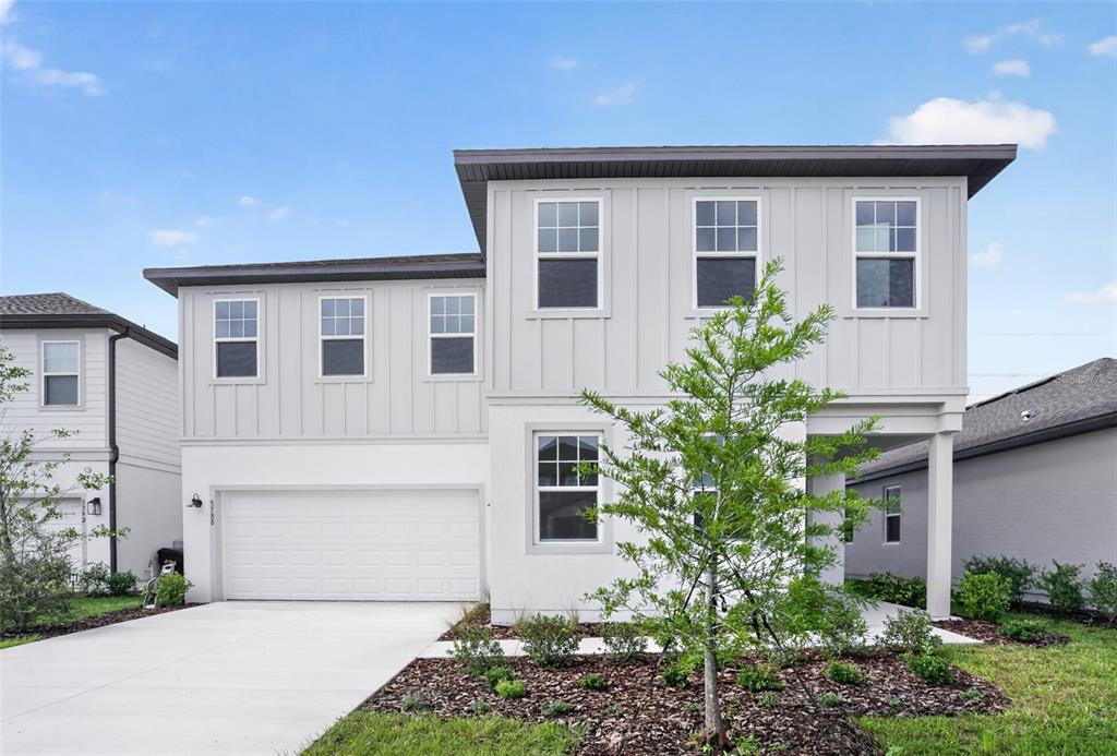 5788 Haystack Drive St. Cloud, FL 34771 - Photo 1 of 31 a front view of a house with garden