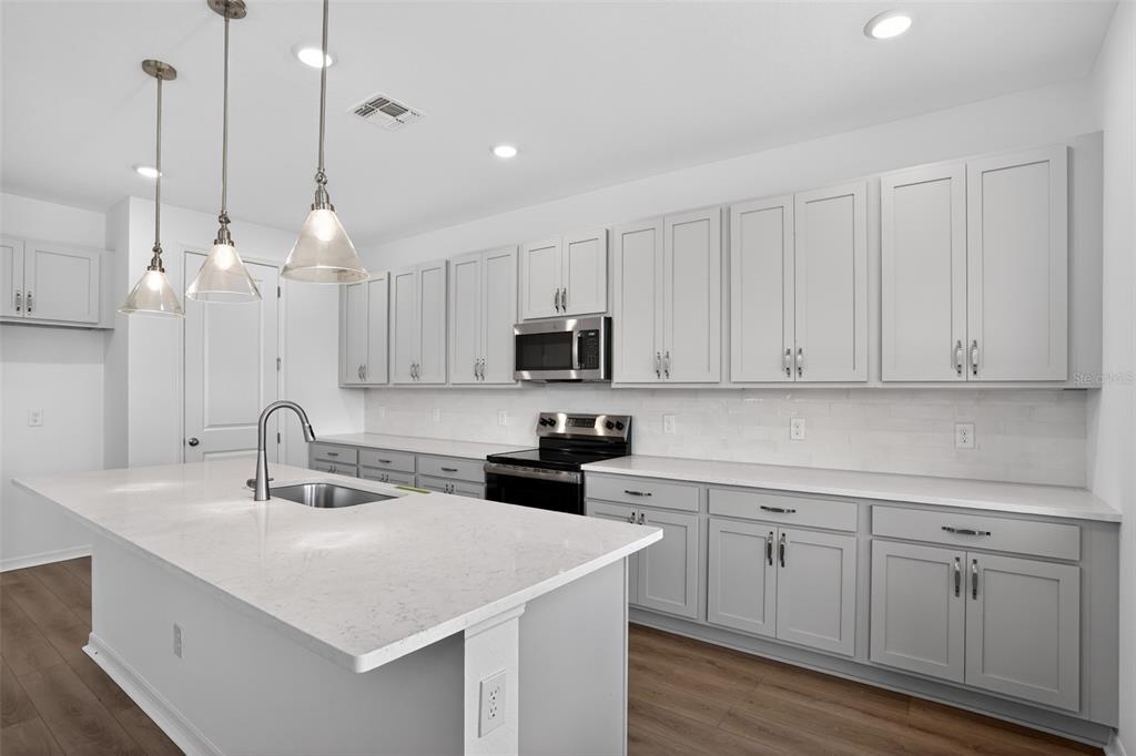5788 Haystack Drive St. Cloud, FL 34771 - Photo 15 of 31 a kitchen with white cabinets and white appliances