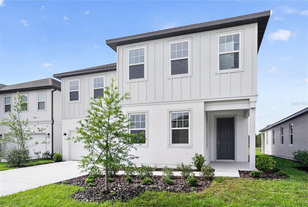 5788 Haystack Drive St. Cloud, FL 34771 - Photo 2 of 31 front view of a house with a yard