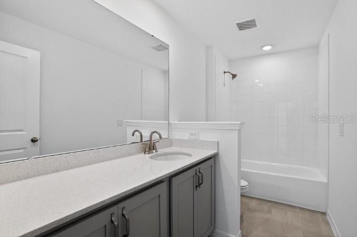 5788 Haystack Drive St. Cloud, FL 34771 - Photo 21 of 31 a bathroom with a sink and a bathtub