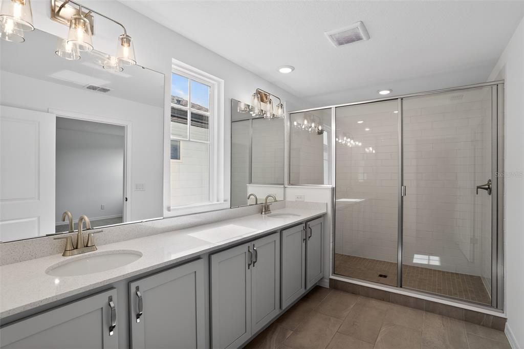5788 Haystack Drive St. Cloud, FL 34771 - Photo 24 of 31 a bathroom with a double vanity sink mirror and double