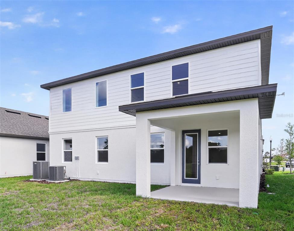 5788 Haystack Drive St. Cloud, FL 34771 - Photo 27 of 31 a front view of a house with a yard