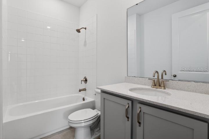 5788 Haystack Drive St. Cloud, FL 34771 - Photo 5 of 31 a bathroom with a sink a toilet and a bathtub