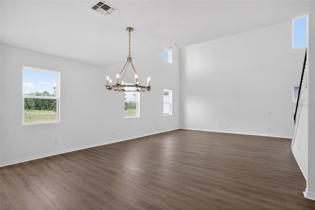 5788 Haystack Drive St. Cloud, FL 34771 - Photo 10 of 31 a view of a room with wooden floor chandelier and a window