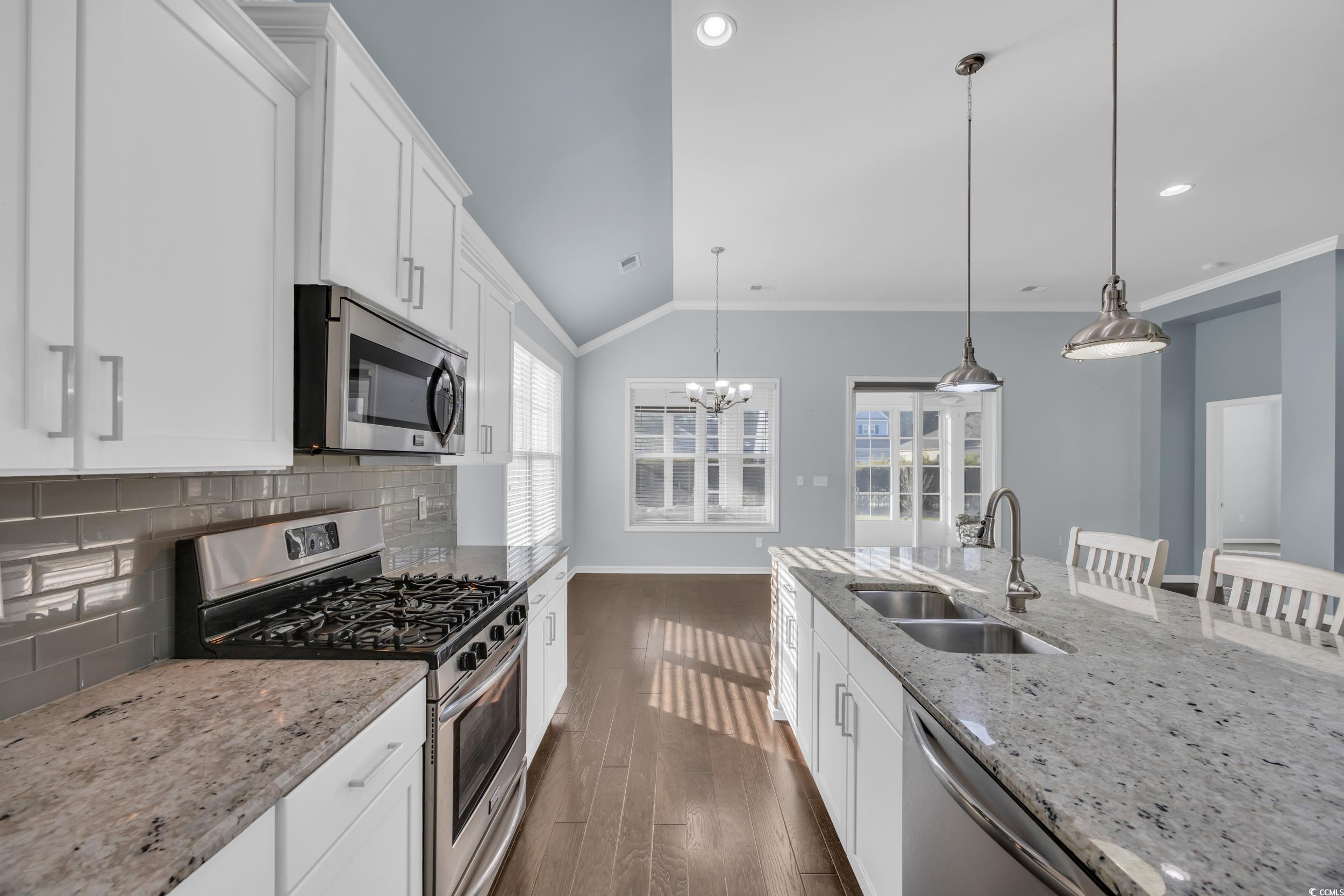 351 Firenze Loop Myrtle Beach, SC 29579 - Photo 11 of 37 Kitchen featuring dark wood-type flooring, crown m
