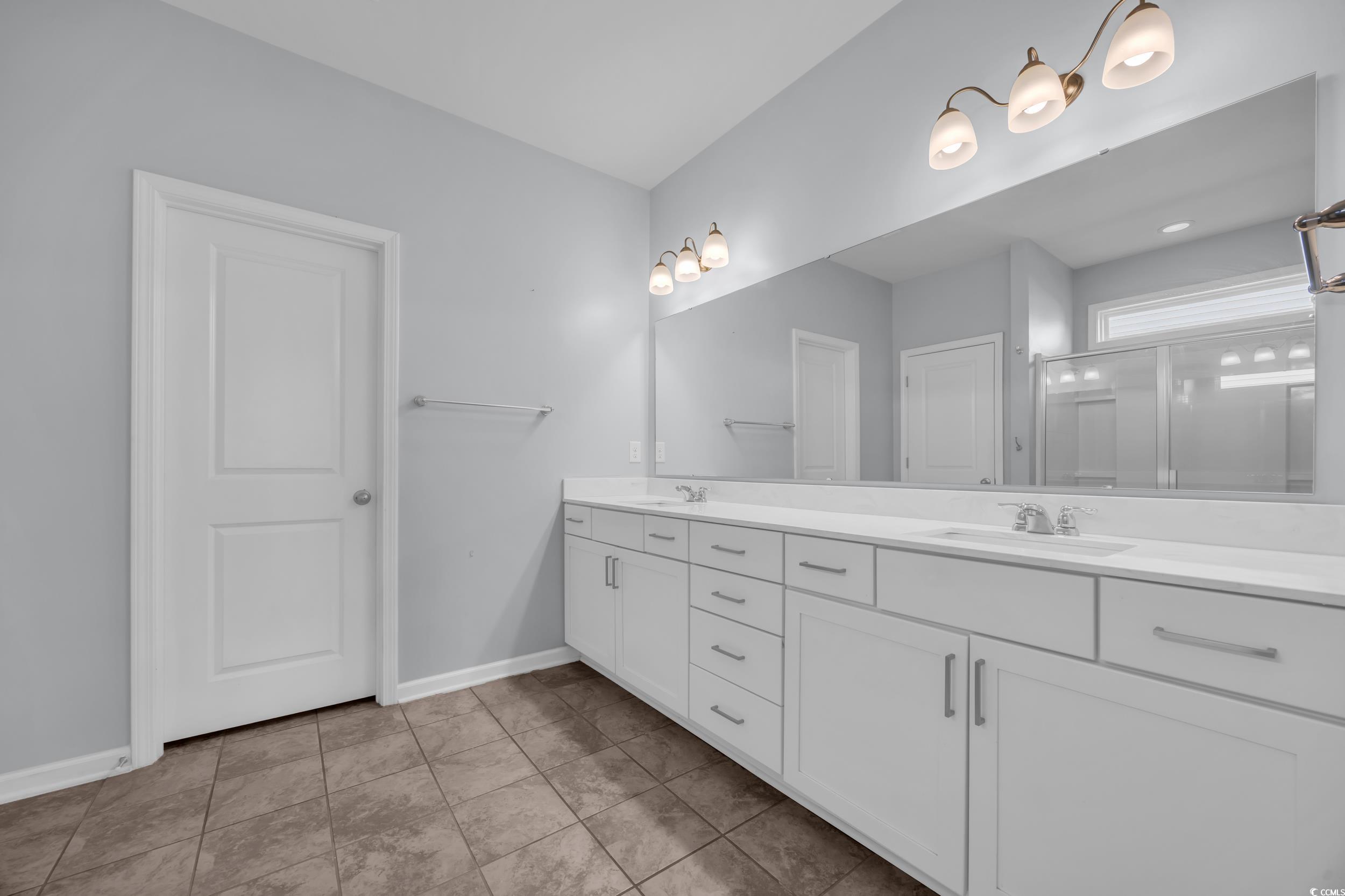 351 Firenze Loop Myrtle Beach, SC 29579 - Photo 16 of 37 Bathroom featuring double vanity, a sink, tile pat