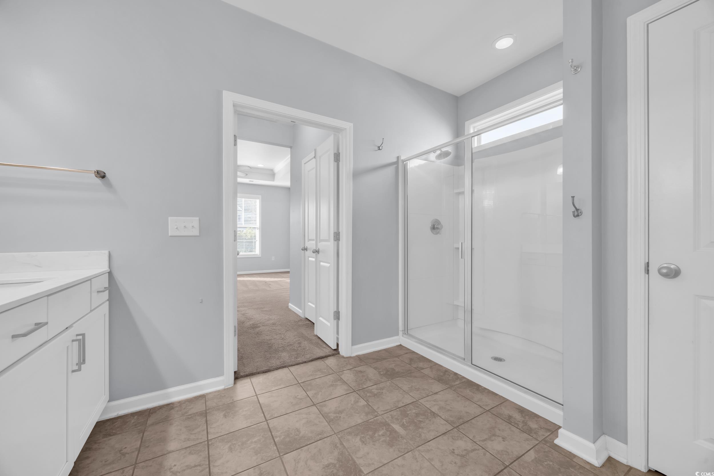 351 Firenze Loop Myrtle Beach, SC 29579 - Photo 17 of 37 Bathroom with baseboards, a stall shower, tile pat