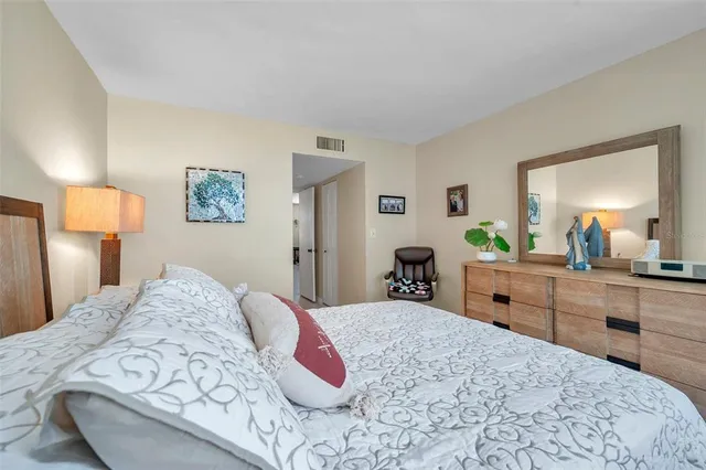 a bedroom with a bed and a dresser