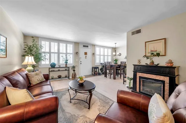 a living room with furniture a potted plant and a window