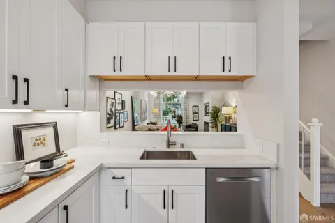 a kitchen with stainless steel appliances a sink and cabinets