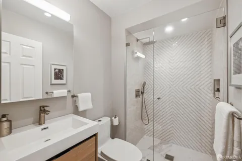 a bathroom with a sink toilet and shower