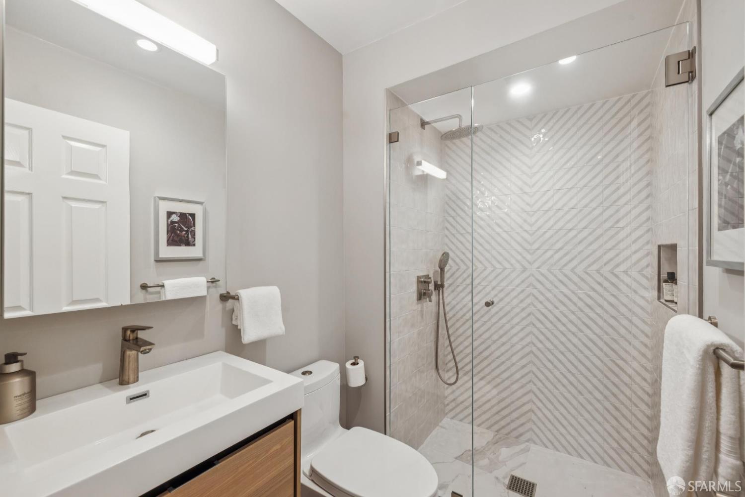 2075 Sutter Street, Unit 215 San Francisco, CA 94115 - Photo 8 of 14 a bathroom with a sink toilet and shower