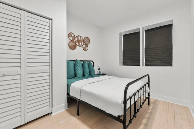 a bathroom with a toilet sink vanity tub and mirror