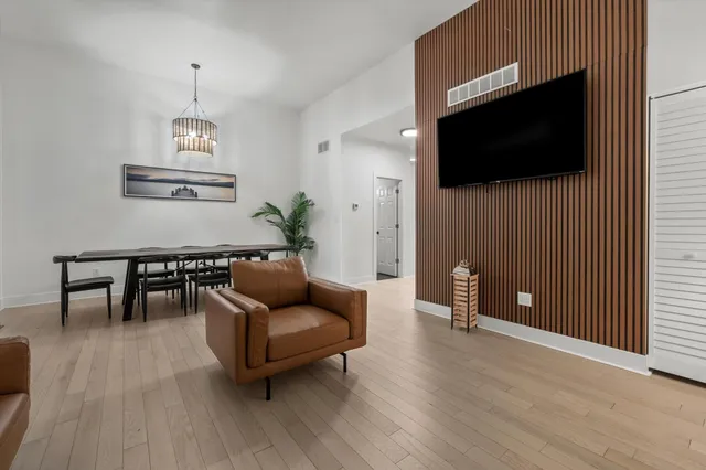 a view of a dining room with furniture and wooden floor