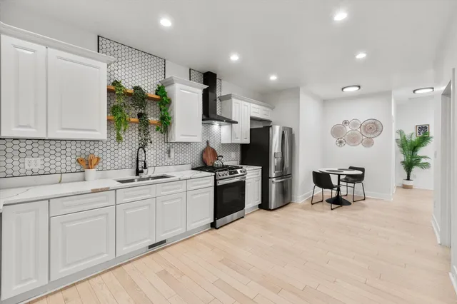 a view of a kitchen with a sink and cabinets