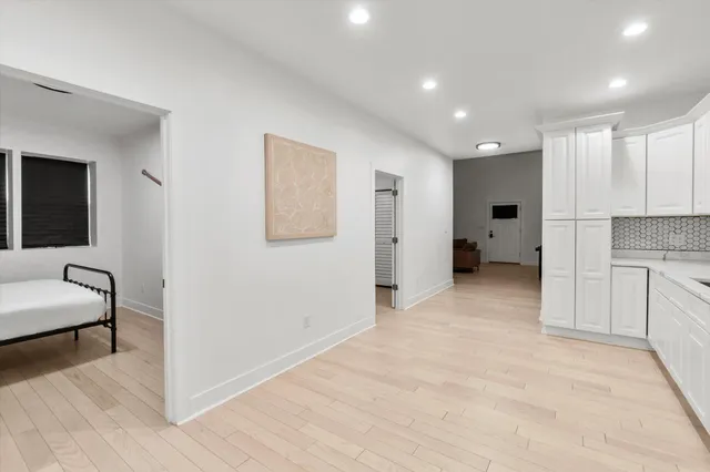 a view of a hallway with dining room and furniture