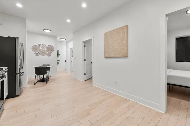 a kitchen with refrigerator and chairs