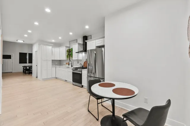 a bathroom with a granite countertop toilet a sink and mirror