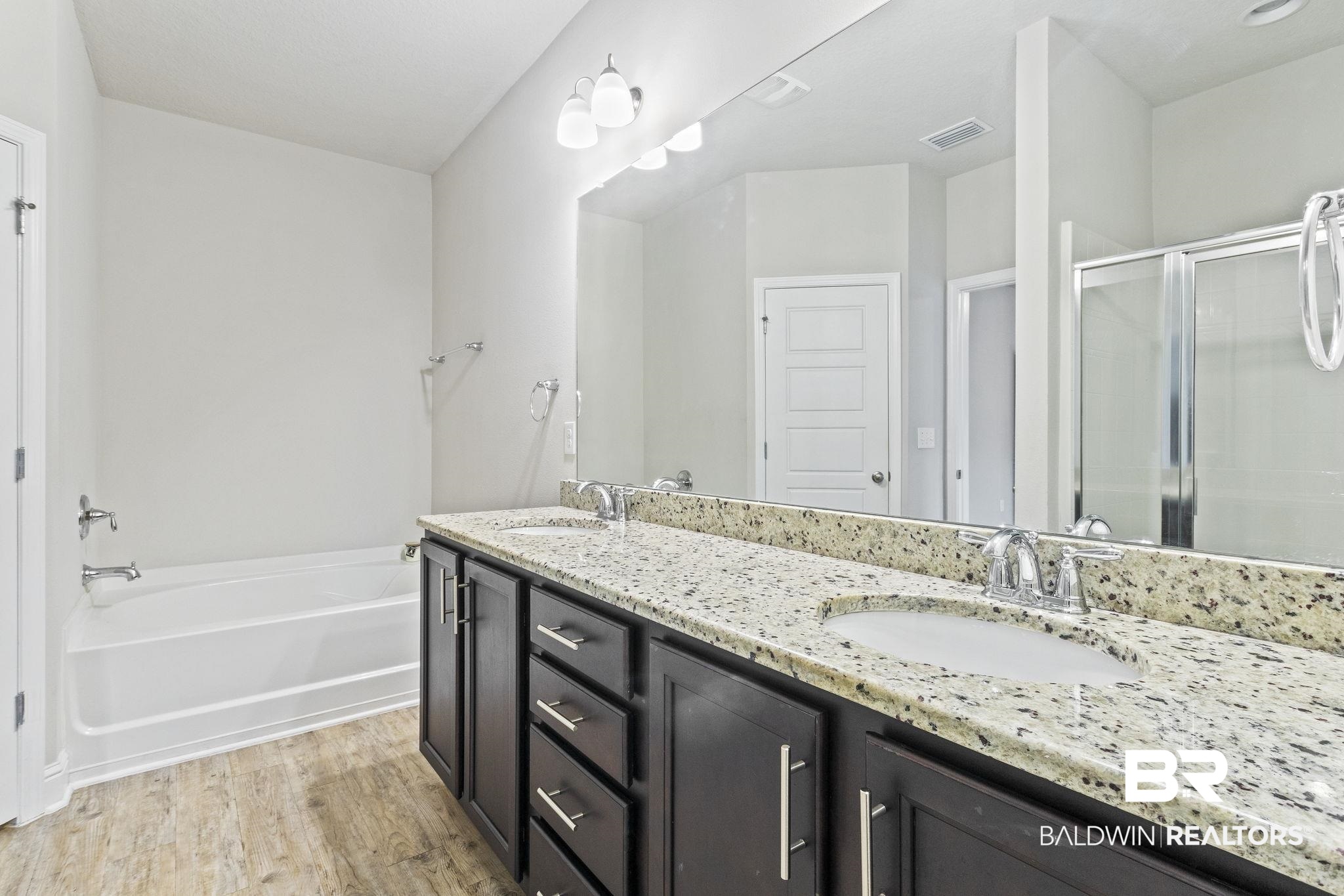 31643 Kestrel Loop Daphne, AL 36527 - Photo 22 of 59 Bathroom featuring vanity, separate shower and tub, and hardwood / wood-style flooring