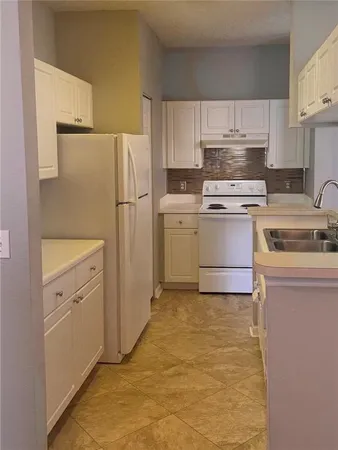 a kitchen with cabinets appliances and a counter space