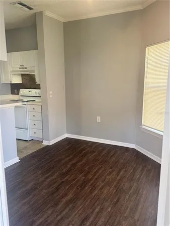 a view of kitchen with wooden floor and electronic appliances