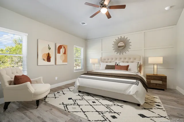 a spacious bedroom with a bed and a chandelier