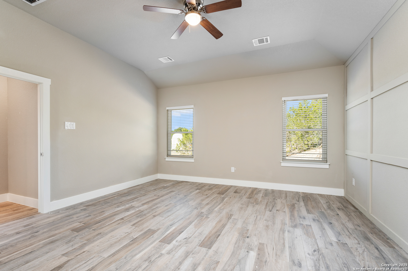 141 Prairie Tea Spring Branch, TX 78070 - Photo 12 of 26 a view of an empty room with a window and wooden floor