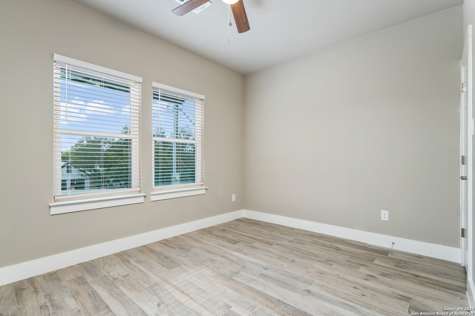 141 Prairie Tea Spring Branch, TX 78070 - Photo 18 of 26 a view of an empty room with wooden floor and a window