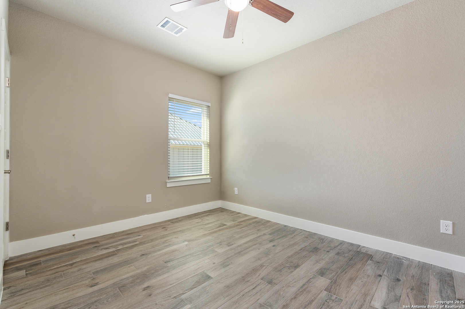 141 Prairie Tea Spring Branch, TX 78070 - Photo 20 of 26 a view of an empty room with wooden floor and a window