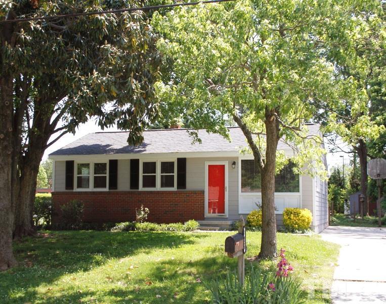 3428 Apache Drive Raleigh, NC 27609 - Photo 1 of 15 a front view of a house with a yard garage and trees