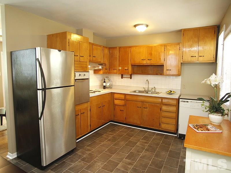 3428 Apache Drive Raleigh, NC 27609 - Photo 6 of 15 a kitchen with stainless steel appliances granite countertop a refrigerator a sink and a stove