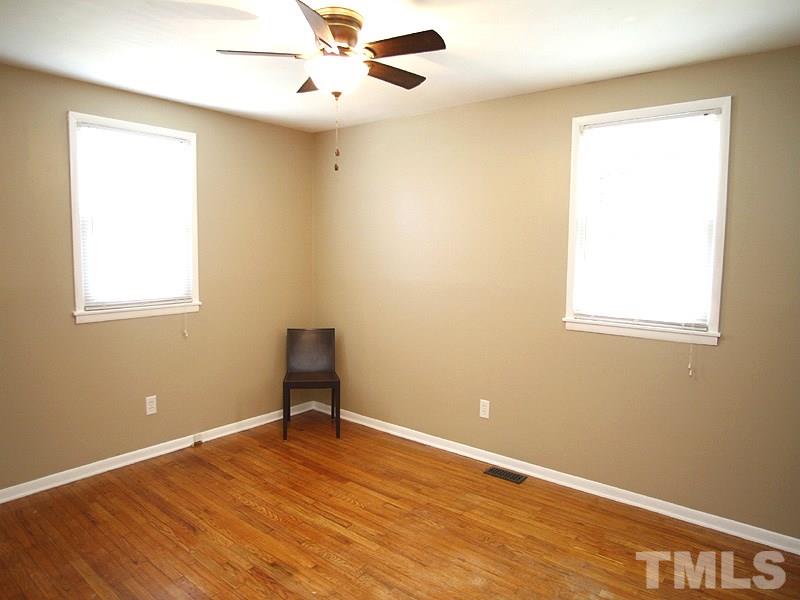 3428 Apache Drive Raleigh, NC 27609 - Photo 7 of 15 a view of an empty room with wooden floor and a window