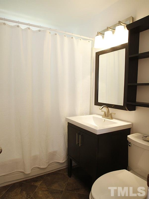 3428 Apache Drive Raleigh, NC 27609 - Photo 8 of 15 a bathroom with a sink and a mirror