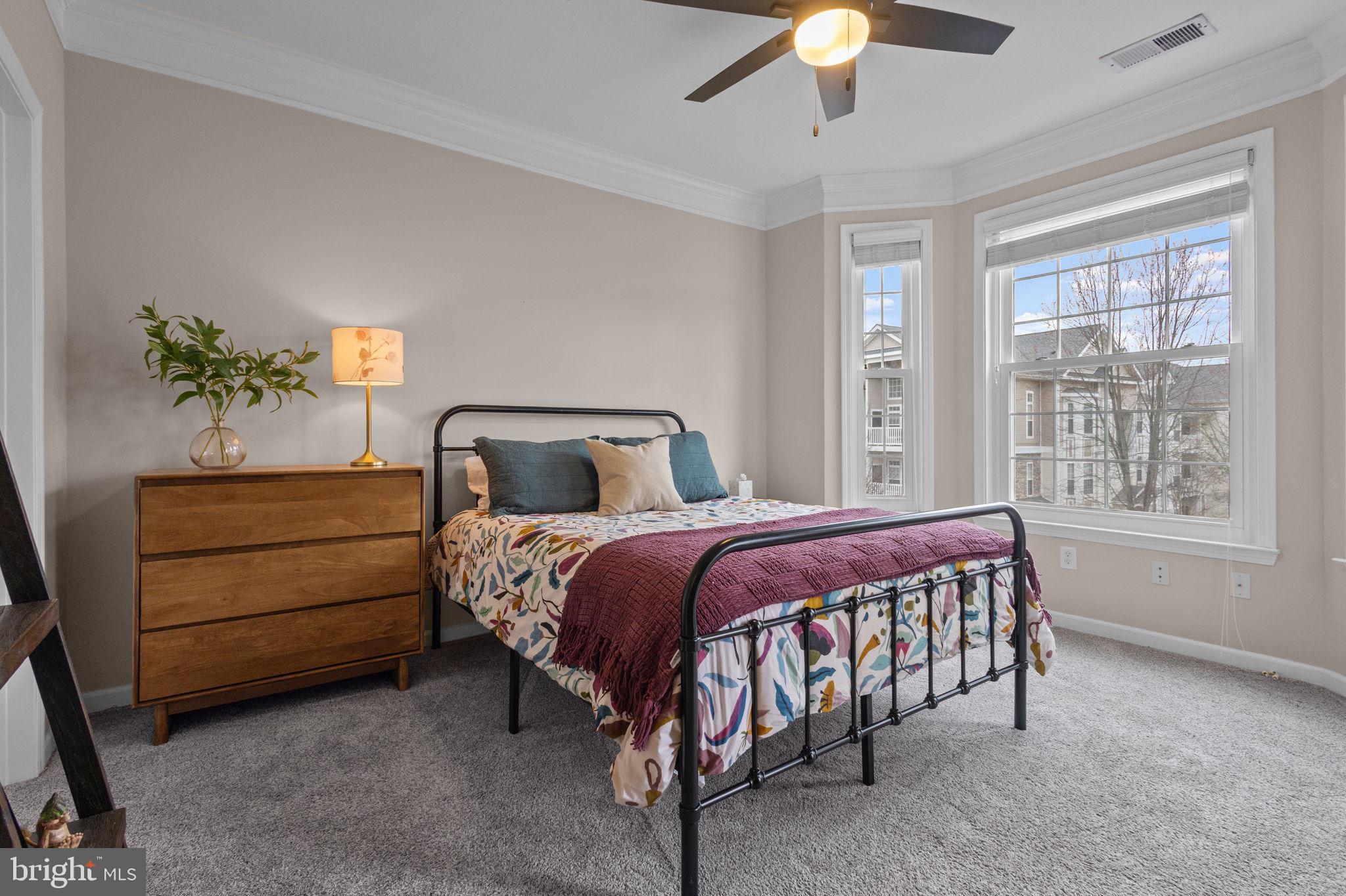 508 Sunset View Terrace Southeast, Unit 302 Leesburg, VA 20175 - Photo 12 of 30 a bedroom with a bed and a chandelier