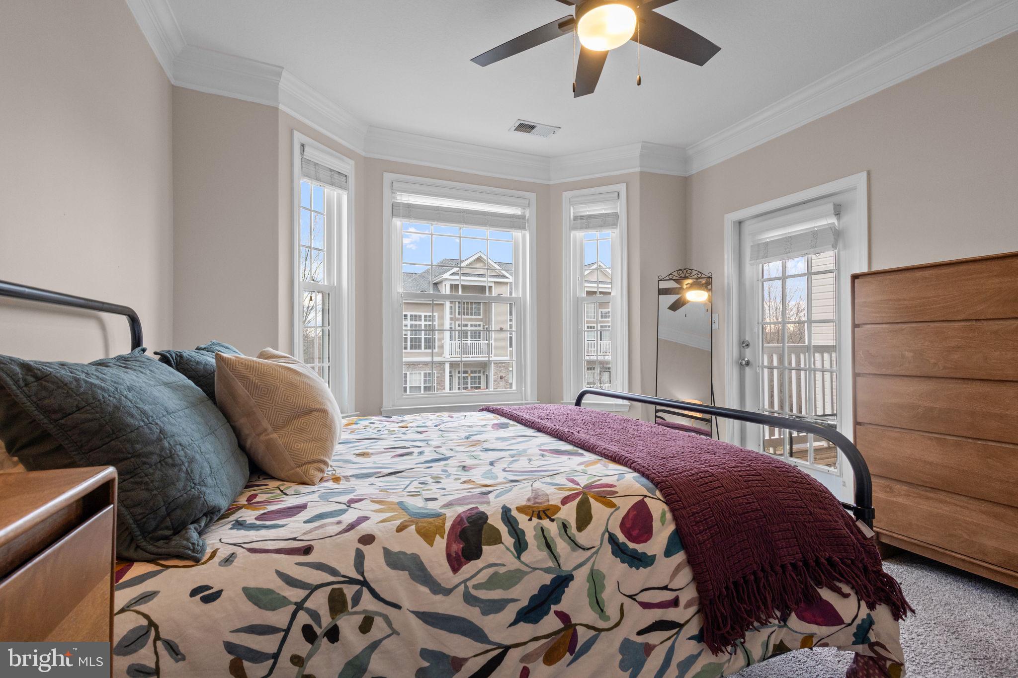 508 Sunset View Terrace Southeast, Unit 302 Leesburg, VA 20175 - Photo 13 of 30 a bedroom with a bed and a chandelier