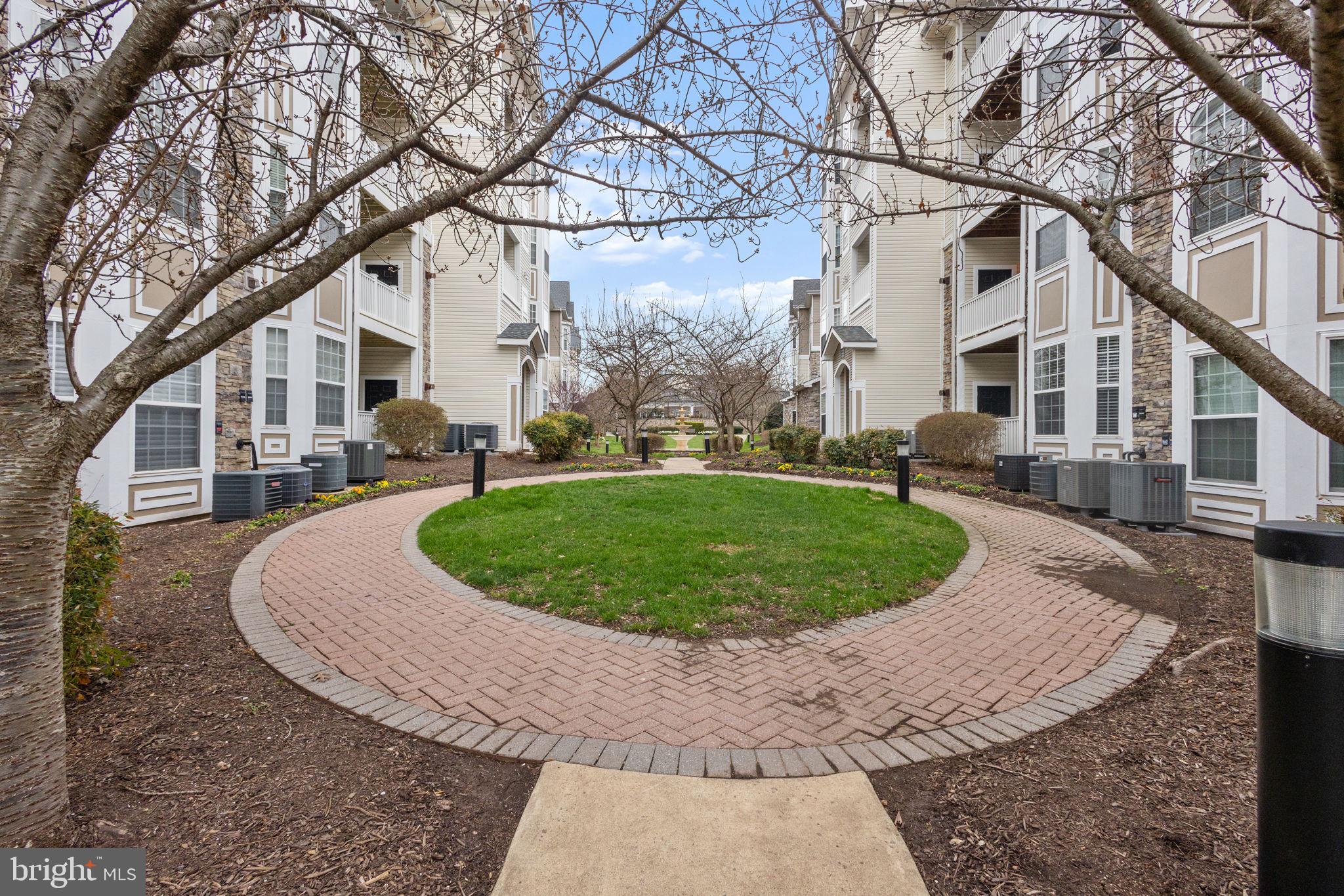508 Sunset View Terrace Southeast, Unit 302 Leesburg, VA 20175 - Photo 29 of 30 front view of a house with a yard