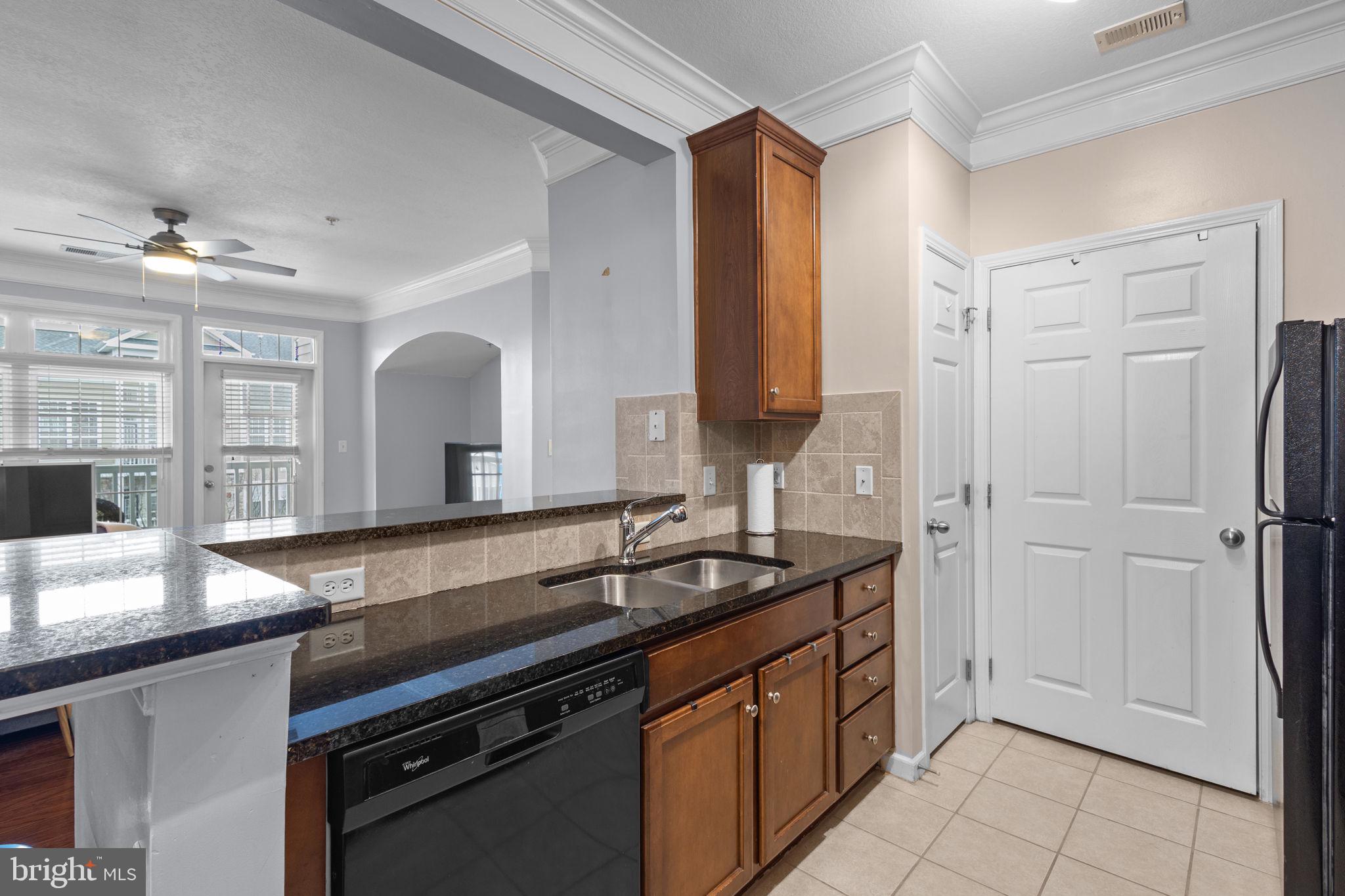 508 Sunset View Terrace Southeast, Unit 302 Leesburg, VA 20175 - Photo 8 of 30 a kitchen with stainless steel appliances granite countertop a sink and a refrigerator