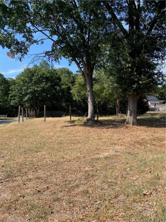 308 Hampton Street Iva, SC 29655 - Photo 4 of 21 The property line goes past the fence to trees.