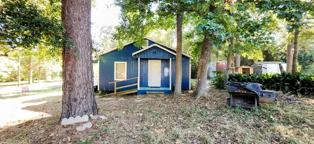 a view of a house with a yard siting area and garden