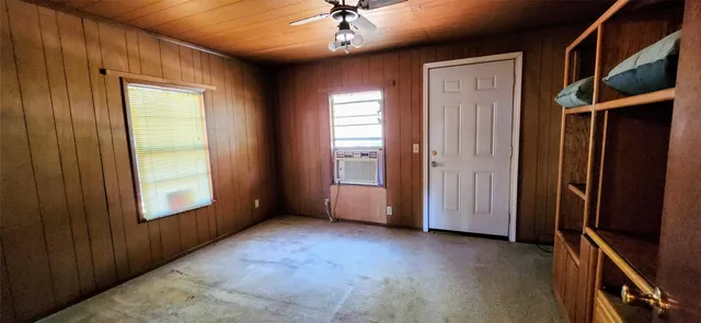 an empty room with windows and closet