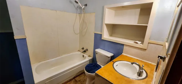 a bathroom with a toilet a sink and a bathtub