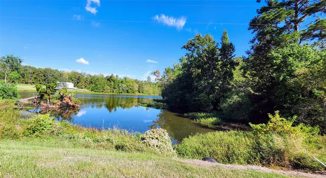 a view of a lake with a house in the background