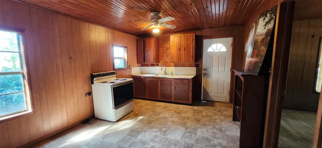 a view of a kitchen with a refrigerator and window