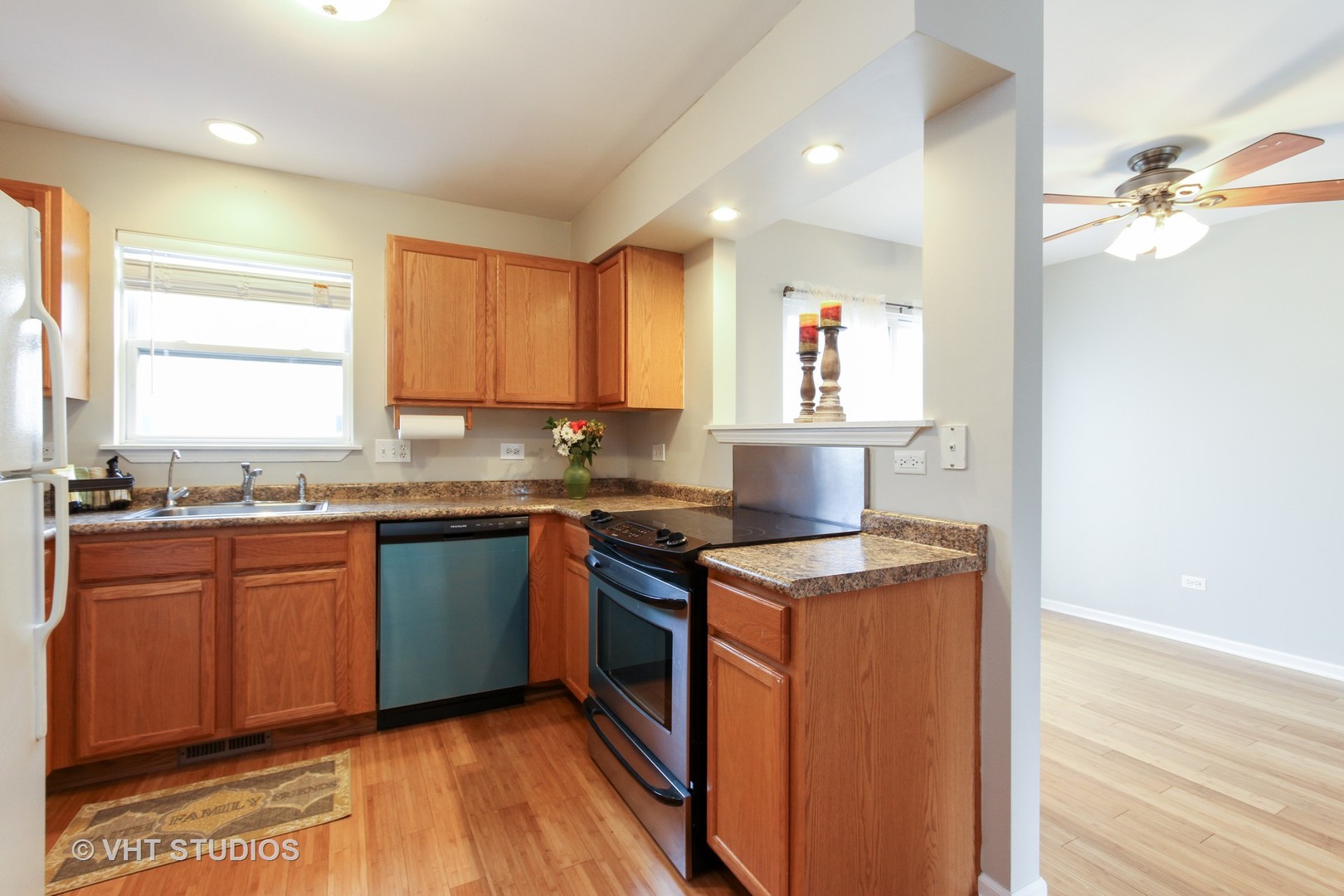 34379 North Barberry Road Round Lake, IL 60073 - Photo 2 of 10 a kitchen with stainless steel appliances granite countertop wooden cabinets a stove a sink and a window