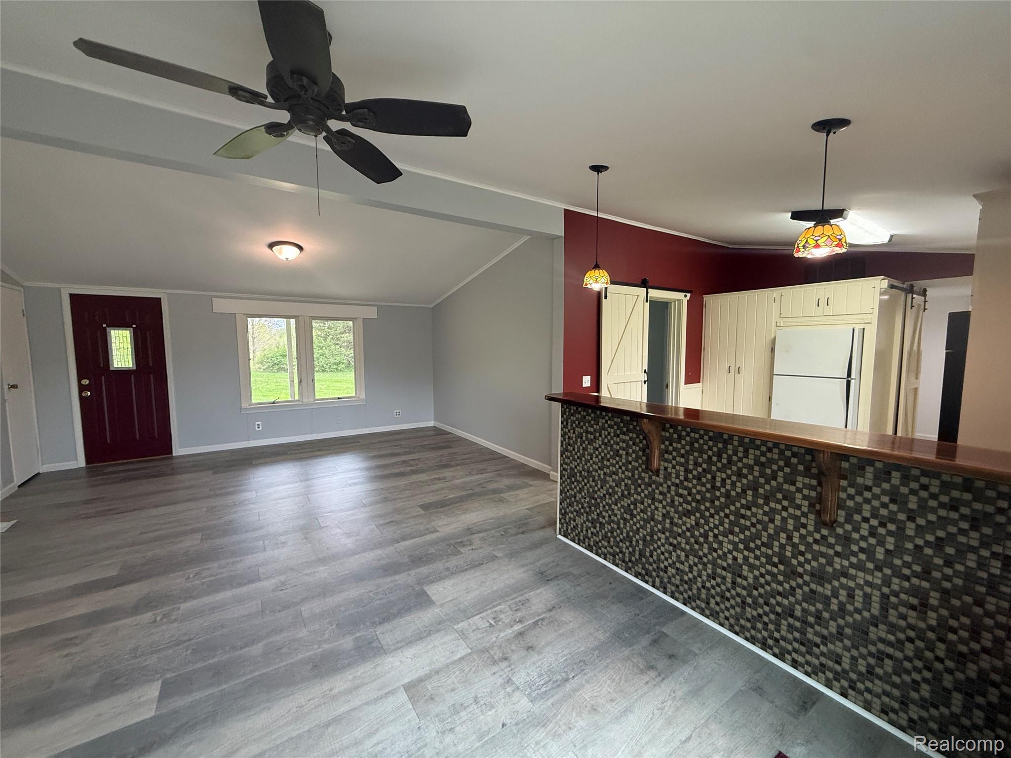 7149-7163 Burpee Road Grand Blanc, MI 48439 - Photo 23 of 72 Unfurnished living room with a ceiling fan, dark wood-type flooring, and vaulted ceiling with beams