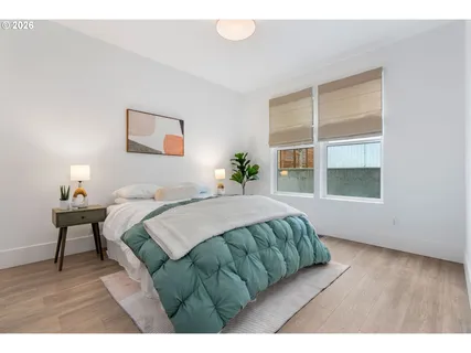 a bedroom with a bed and a window