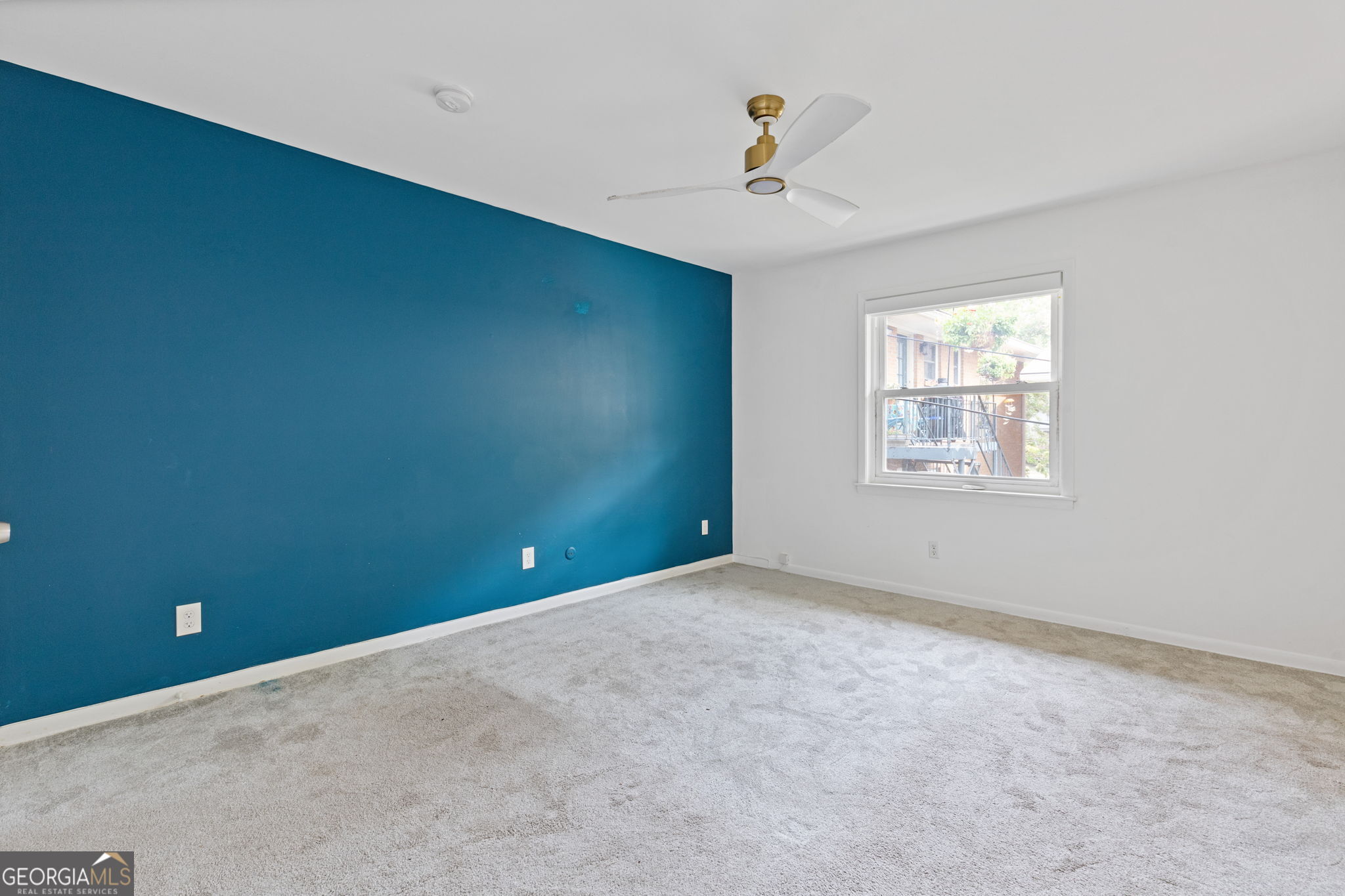 3510 Roswell Road Northwest, Unit C2 Atlanta, GA 30305 - Photo 12 of 24 an empty room with windows and ceiling fan