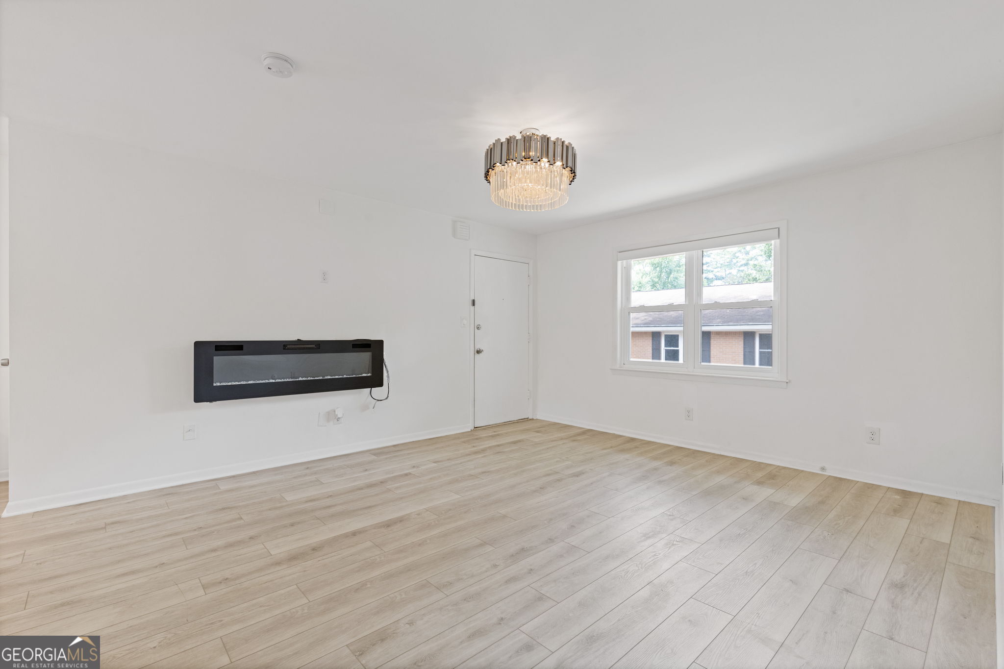 3510 Roswell Road Northwest, Unit C2 Atlanta, GA 30305 - Photo 5 of 24 a view of an empty room with a window and wooden floor