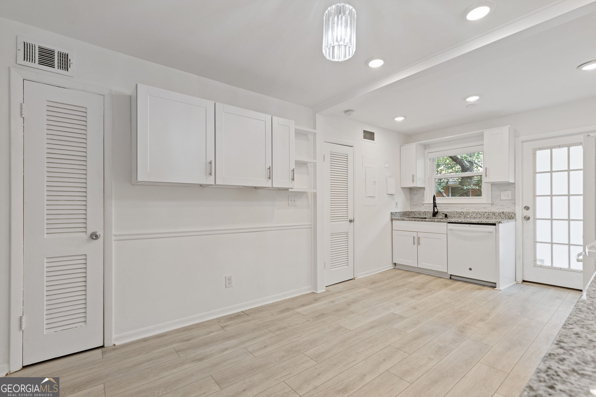 3510 Roswell Road Northwest, Unit C2 Atlanta, GA 30305 - Photo 8 of 24 a large white kitchen with window and stainless steel appliances