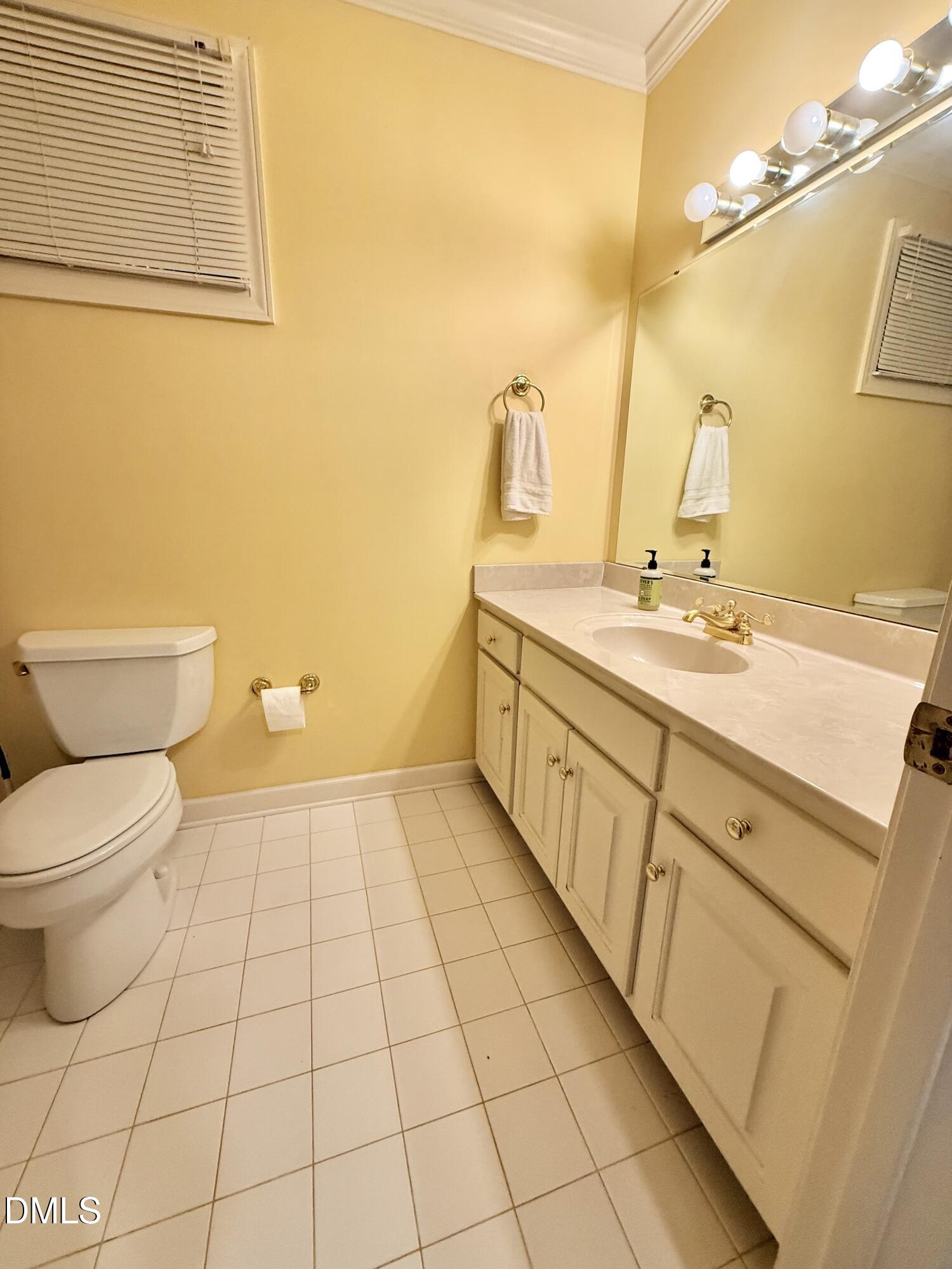 81 Beaver Crossing Road Roxboro, NC 27574 - Photo 41 of 80 a bathroom with a granite countertop toilet sink and mirror